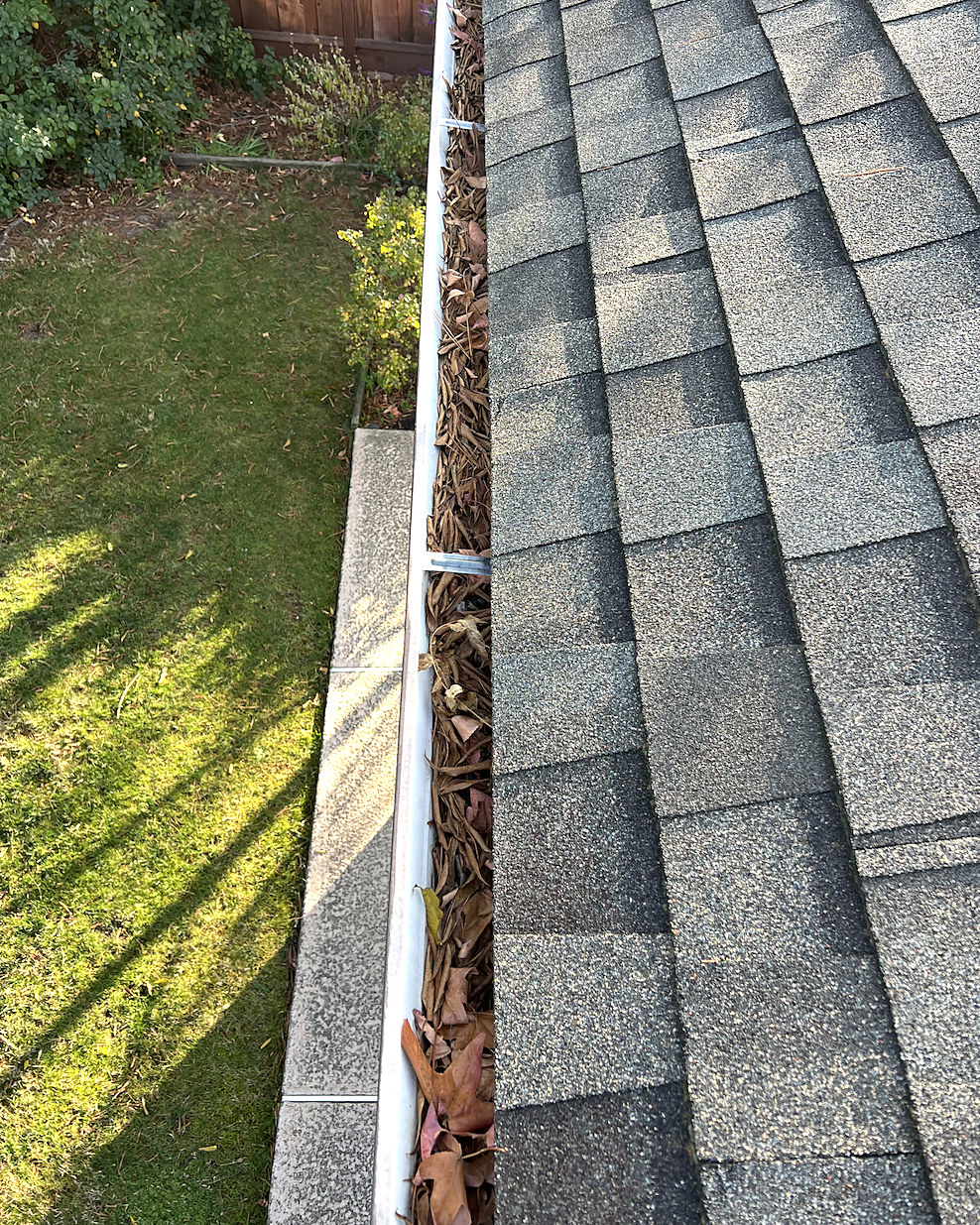 Packed gutter, cleared by hand, before cleaning